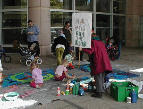 Kids painting a peace banner